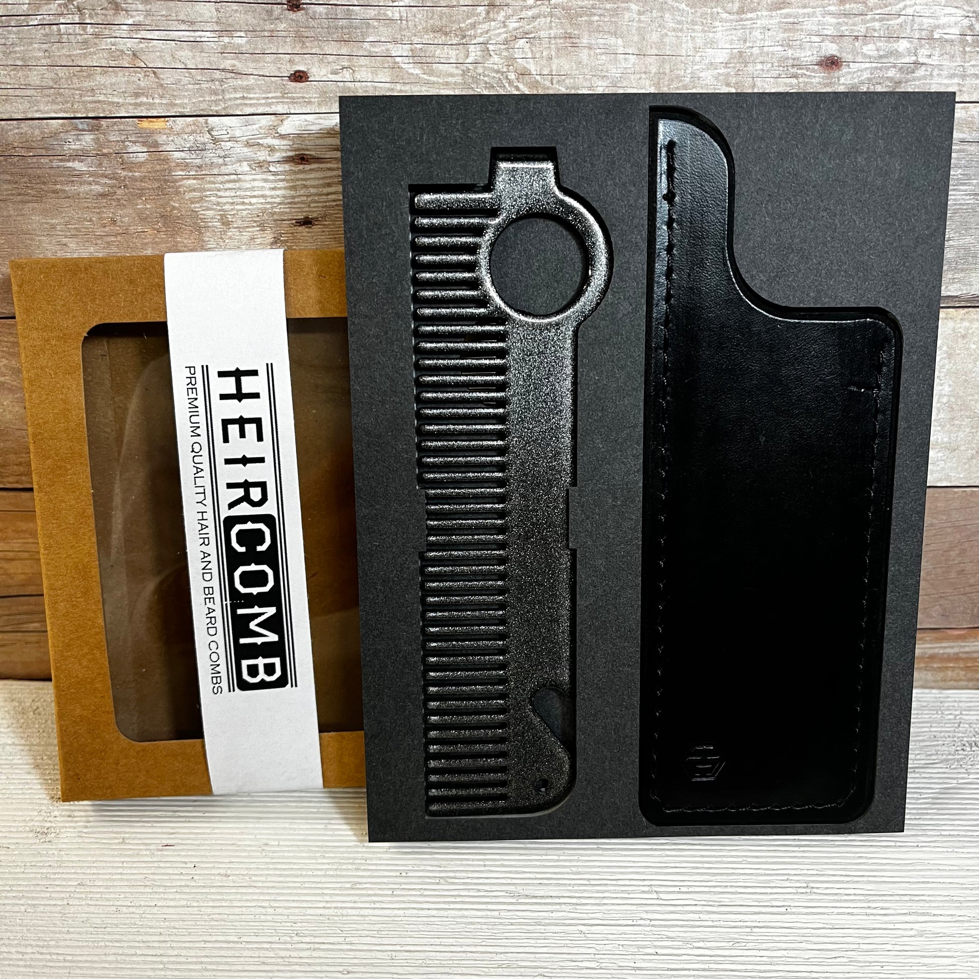 Heircomb Executor Metal Comb in Gunmetal finish with Black Leather Sheath.