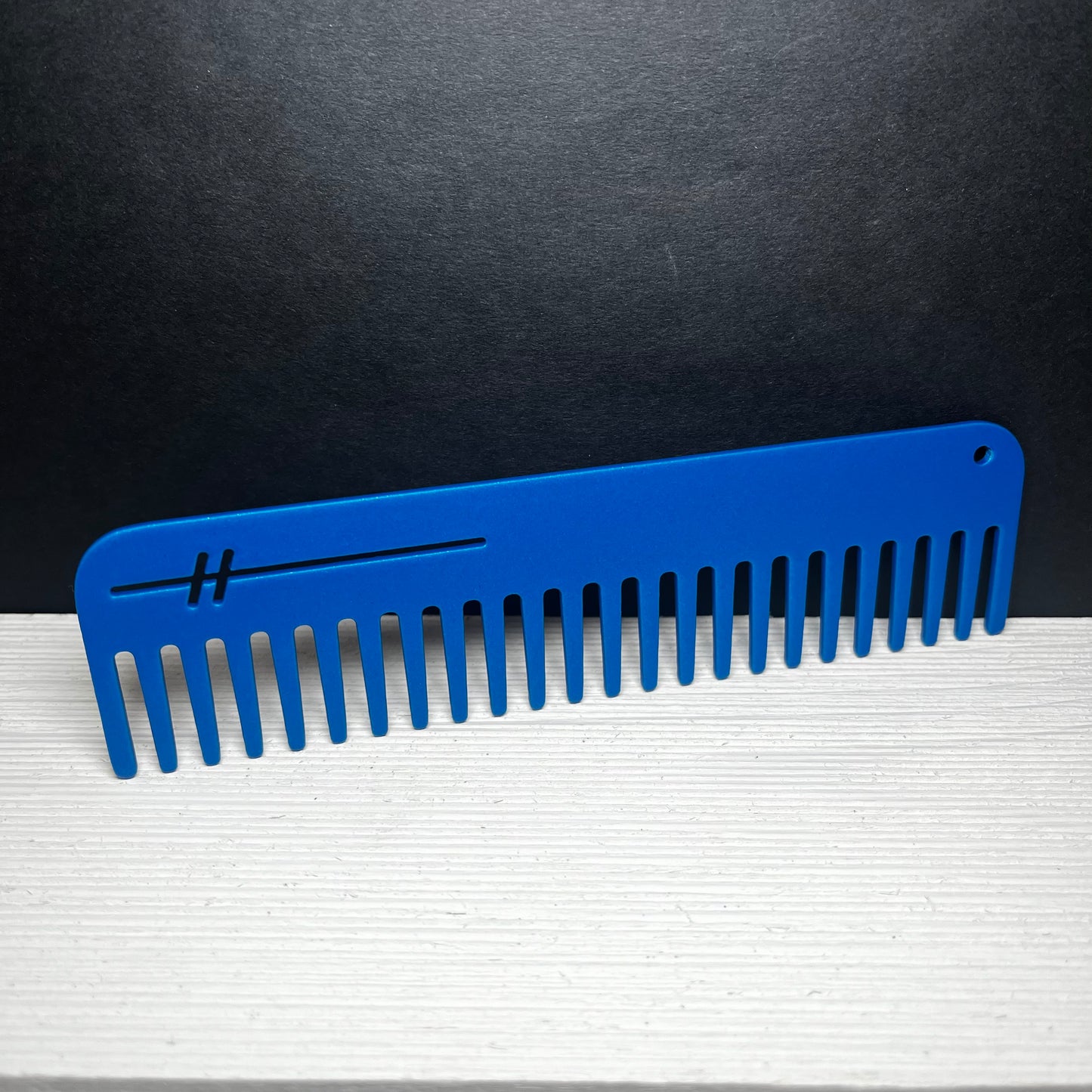 Heircomb Abbey Wide Tooth Metal Comb in Matte Blue finish.